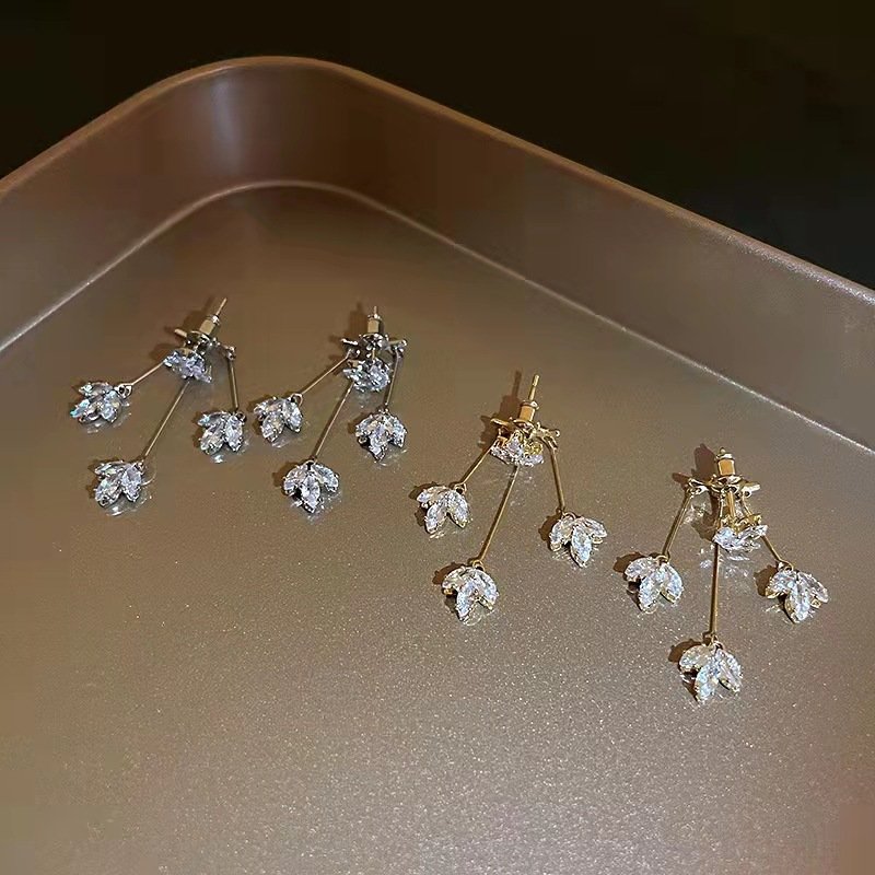 Maple's dangling flower-shaped earrings